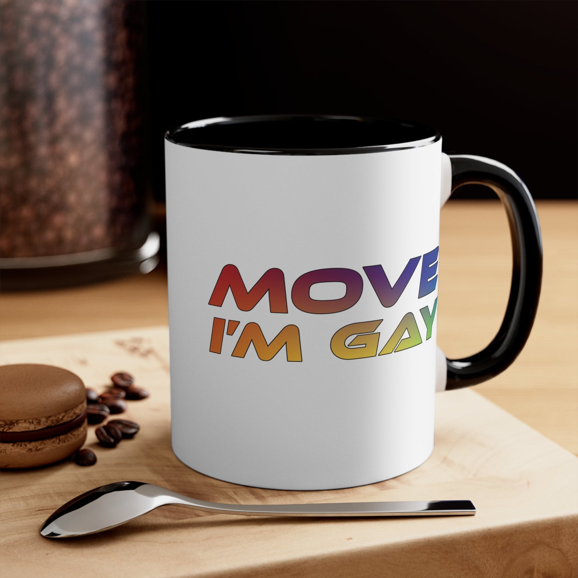 The MOVE I'M GAY accent mug by Printify features a clean white exterior with a striking blue handle and rim, and showcases bold, rainbow-colored "MOVE I'M GAY" text on its vibrant interior.