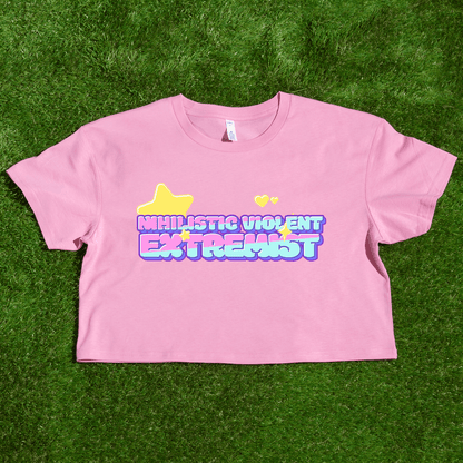 The Nihilistic Violent Extremist locally printed satire crop tee is a pink top with colorful bubble text, a yellow star, and two hearts, designed by a trans and queer owned brand 