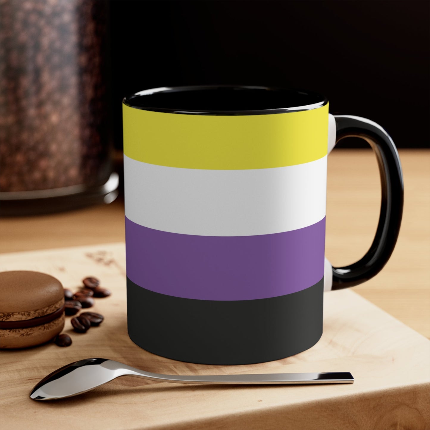 The Non-binary Pride Flag colourful accent mug by Printify features a ceramic design with a black handle and interior, adorned with vibrant horizontal stripes in yellow, white, purple, and black for an eye-catching color contrast.