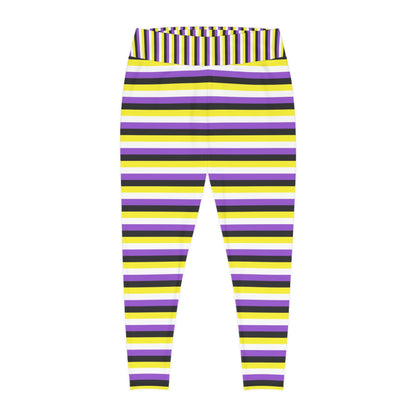 A person wearing Printify's Non-Binary Pride Flag Plus Size Leggings, sizes 2XL - 6XL, which feature high-waisted, colorful horizontal stripes in black, purple, yellow, and white. Made from 4-way stretch fabric for comfort and flexibility, they stand with their feet slightly apart. Only their legs and part of their torso are visible. They are also wearing white sneakers.