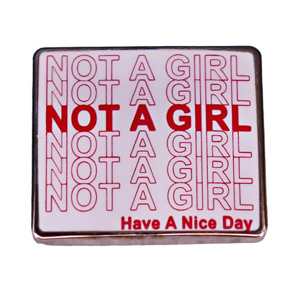 Enamel pin with 'Not a Girl' red text pattern on a white background