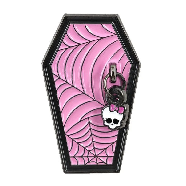 A coffin-shaped enamel pin with a pink and black spiderweb pattern, featuring a small skull charm with a pink bow and a key ring at the top. 