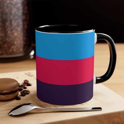 The Polyamory Pride Flag cup - colorful accent mug by Printify features a white coffee mug with a red handle and a vibrant interior. The exterior design showcases a colorful heart on a white background, accompanied by distinctive elements including a blue triangle, pink stripe, and purple stripe.