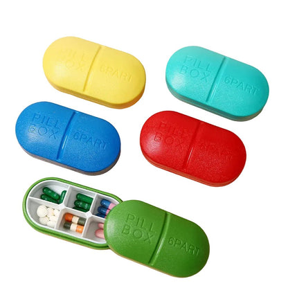 Five pill box travel organizers in different colors (yellow, turquoise, blue, red, and green). One green pill box is open, showing compartments filled with various colorful pills.