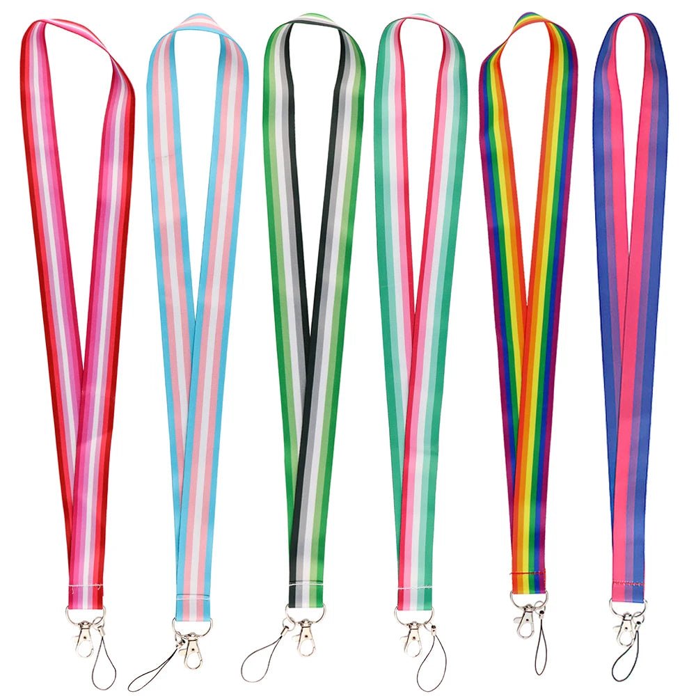 Six vibrant Pride Flag Lanyards from Gay Skate are displayed against a white background. Each practical neck strap showcases a distinctive design representing different pride flags: Rainbow, Trans, Non-Binary, Lesbian, Bisexual, Abrosexual/Abroromantic, and Aromantic. Every lanyard comes with a sturdy metal clip for securing keys or an ID.