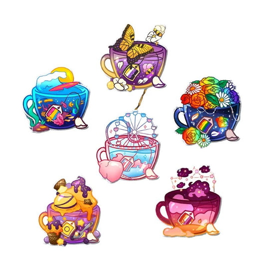 Introducing the Pride Flag Teacup Acrylic Pin collection from Gay Skate, featuring teacups embellished with unique themes such as butterflies, ocean waves, flowers, a Ferris wheel, ice cream, and clouds. Each design highlights vibrant elements like rainbows or pride flag motifs alongside candy patterns, creating a playful and artistic display.