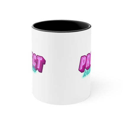 The Protect Trans Kids colourful accent mug by Printify is a white ceramic mug with a black handle and inner rim. It features a vibrant design that says "PROTECT trans kids" in bold, gradient lettering. The word "PROTECT" is in pink and purple, while "trans kids" is in teal, showcasing transgender pride.