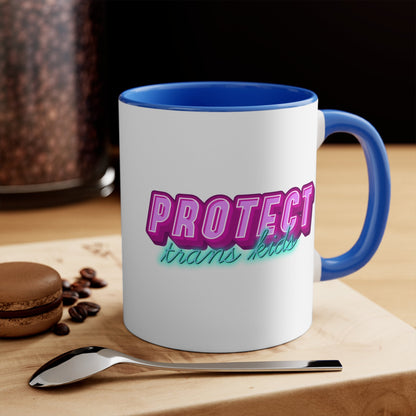 The Protect Trans Kids colourful accent mug by Printify is a white ceramic mug with a black handle and inner rim. It features a vibrant design that says "PROTECT trans kids" in bold, gradient lettering. The word "PROTECT" is in pink and purple, while "trans kids" is in teal, showcasing transgender pride.