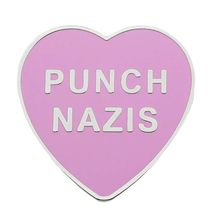 Heart-shaped pink enamel pin with 'PUNCH NAZIS' text 
