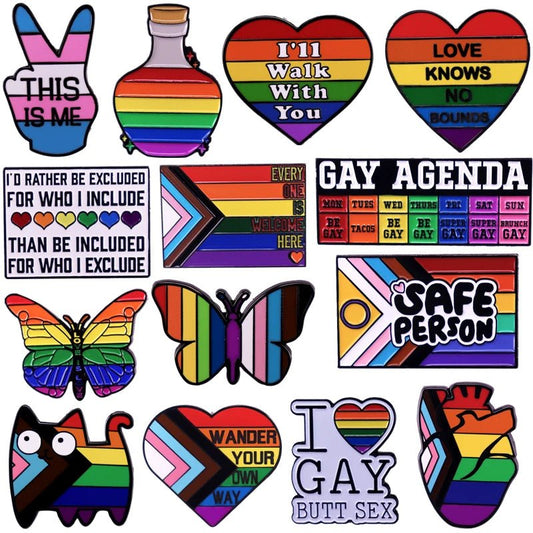 Queer, Trans pride and Ally enamel pin badges from Gay Skate feature vibrant LGBTQ+ themed designs with symbols like hearts, rainbows and butterflies, alongside slogans like "Love Knows No Bounds," celebrating gay, lesbian, and trans pride with rainbow colors and motifs. Gay pride and trans pride badge