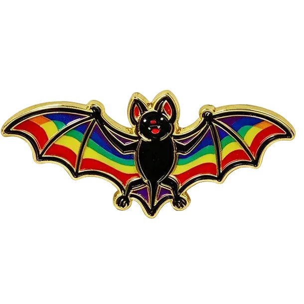 A bat-shaped enamel pin with rainbow-coloured wings and a black body