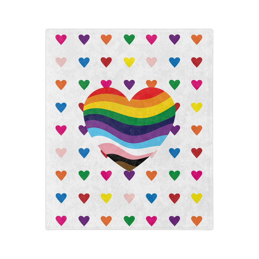 The Rainbow Pride Love Hearts - Velveteen Microfiber Blanket from Printify features a large heart with rainbow and pride flag colors, surrounded by smaller multicolored hearts on white, crafted from super-soft fleece by a trans and queer-owned business.