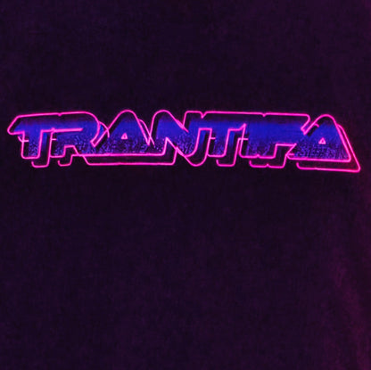 TRANTIFA - Locally printed crop tee features the word "TRANTIFA" in bold, neon pink and blue retro-style lettering against a dark background.