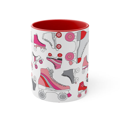 The Roller Skate cup from Printify is a white ceramic mug featuring a vibrant pattern of pink, red, and gray quad skates. The mug also highlights a red handle and interior that complement its playful design.