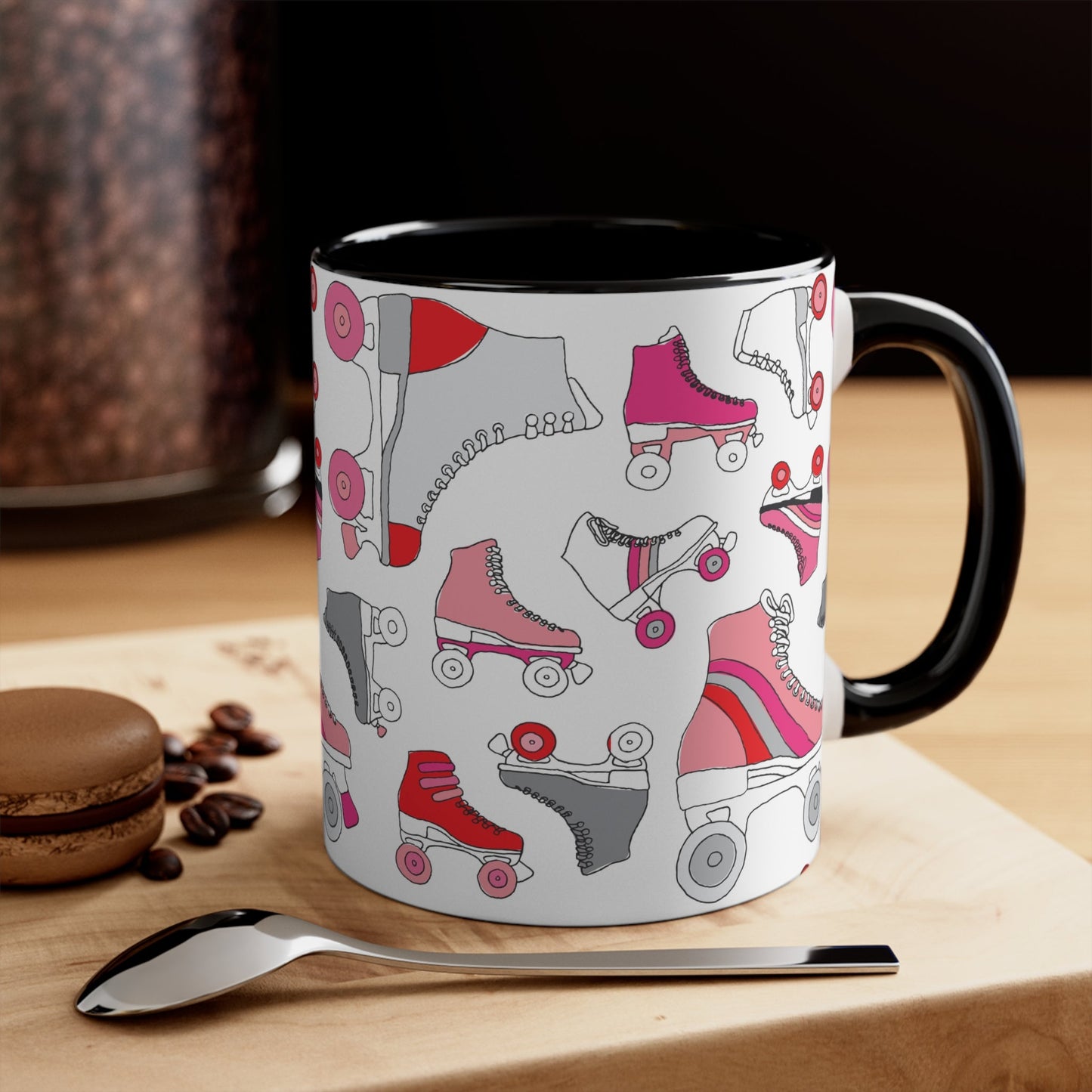 The Roller Skate cup from Printify is a white ceramic mug featuring a vibrant pattern of pink, red, and gray quad skates. The mug also highlights a red handle and interior that complement its playful design.