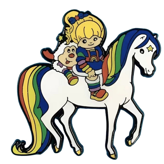 RAINBOW BRITE Colorful enamel pin of a girl riding a unicorn on a blue background
