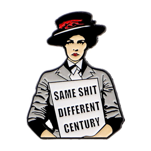 Enamel pin with a female sufragettte holding a sign reading 'Same Shit Different Century' 