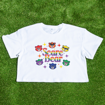 The SCARE BEAR fundraiser tee is a white crop top featuring colorful cartoon bear faces, "Scare Bear" in rainbow letters, and sparkling stars—locally hand printed and perfect for a fun squad or roller derby shirt.