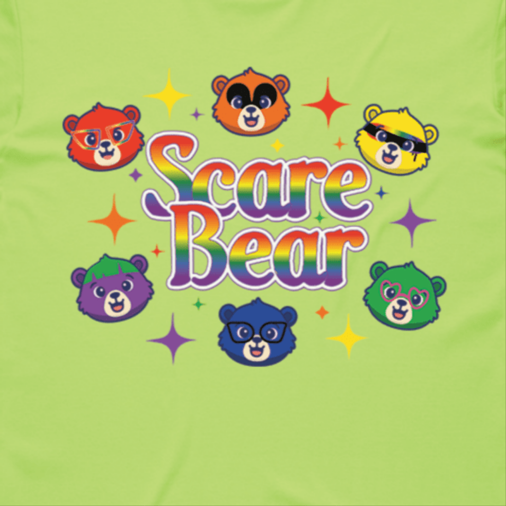 Colorful cartoon bear faces and rainbow “Scare Bear” text with stars decorate this light green SCARE BEAR fundraiser tee—a locally hand printed t-shirt perfect for gay skate or your roller derby squad!.