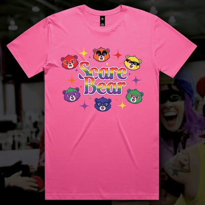 The SCARE BEAR fundraiser tee is a locally hand-printed pink shirt with “Scare Bear” in bold, five colorful bear faces, and star sparkles—perfect for roller derby or your next GAY SKATE event.