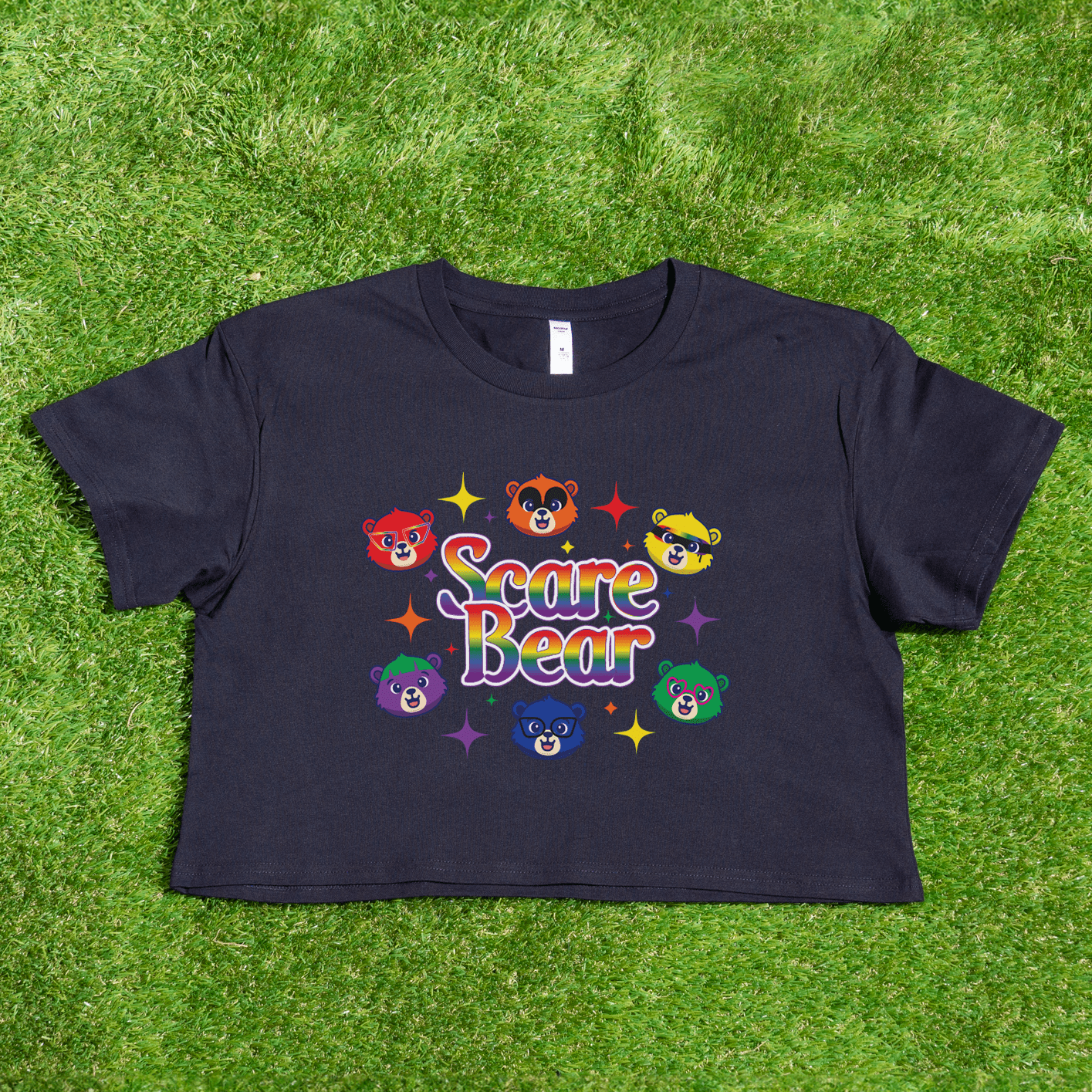 A black SCARE BEAR fundraiser tee with cartoon bear faces and stars, "Scare Bear" rainbow text, hand printed locally—fun for GAY SKATE or roller derby.