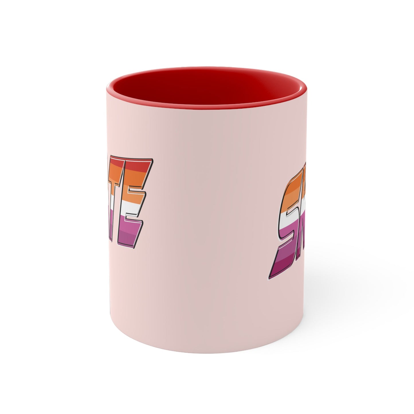 The SKATE lesbian pride flag accent mug by Printify features a bold "SKATE" design in gradient colors of orange, pink, and purple. This eye-catching ceramic mug boasts a light pink handle and interior that beautifully contrast with its pale pink exterior.