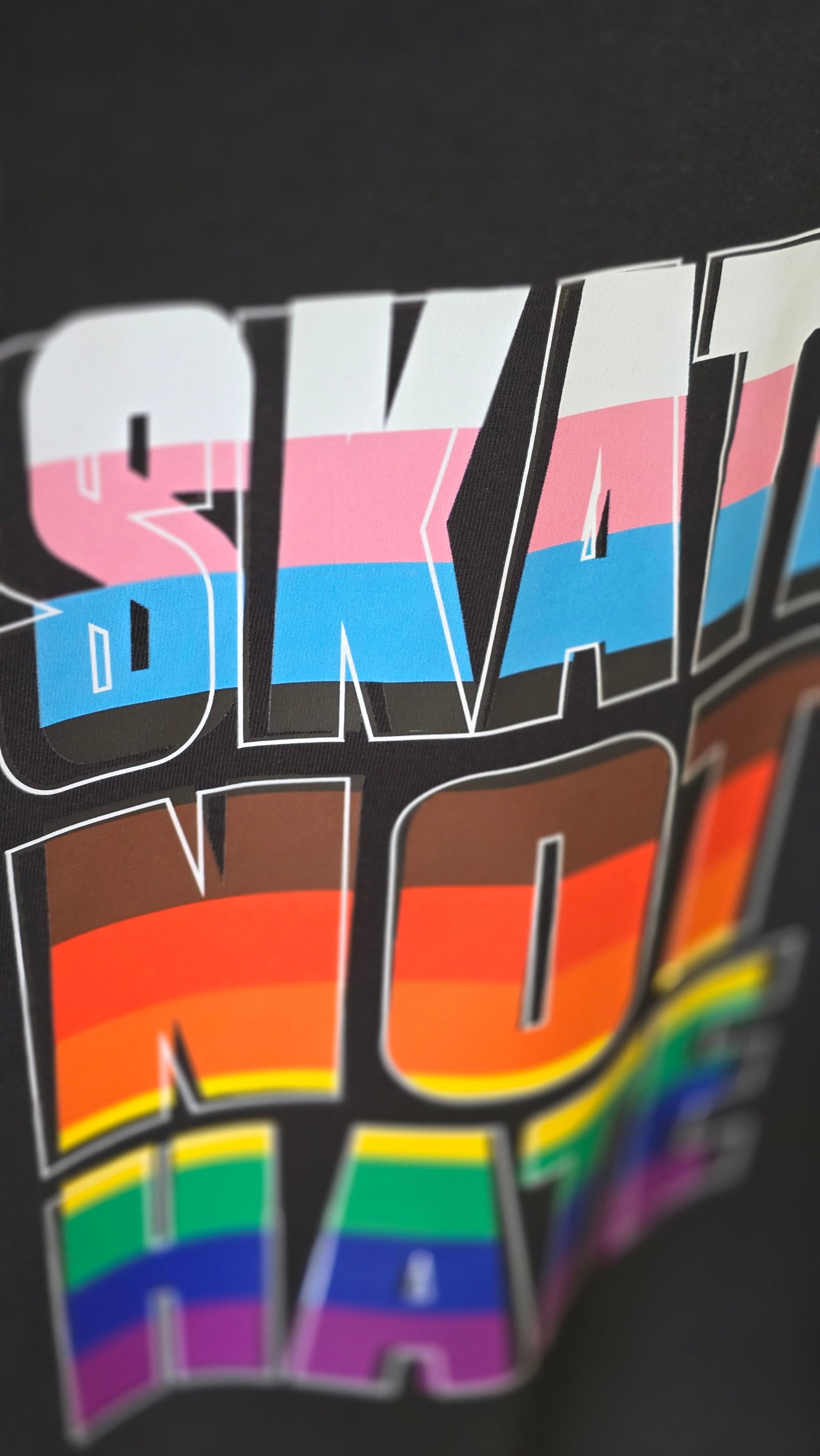 AS Colour WO Crop t-shirt with 'SKATE NOT HATE' text in inclusive rainbow pride flag colours
