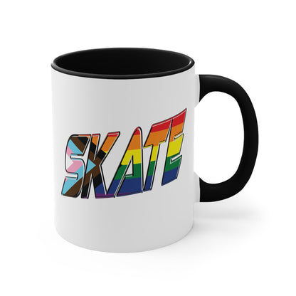 The SKATE progress pride flag accent mug by Printify features a white coffee mug with a red handle and a colorful interior. The front boldly displays the word "SKATE" in rainbow colors, including shades of blue, pink, white, and brown.