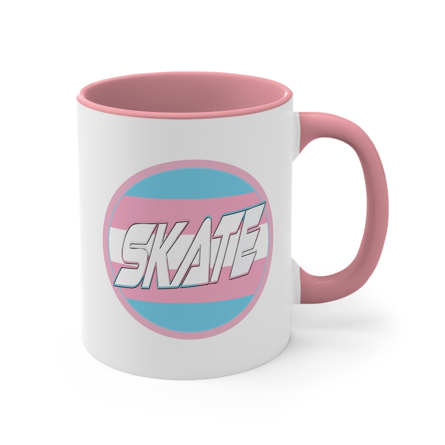 The SKATE trans flag circle design accent mug by Printify features a white exterior, blue handle, and blue interior. It showcases a circular design inspired by the trans flag, incorporating pink, light blue, and white colors. The word "SKATE" is prominently displayed in dynamic white letters at the center of the design.