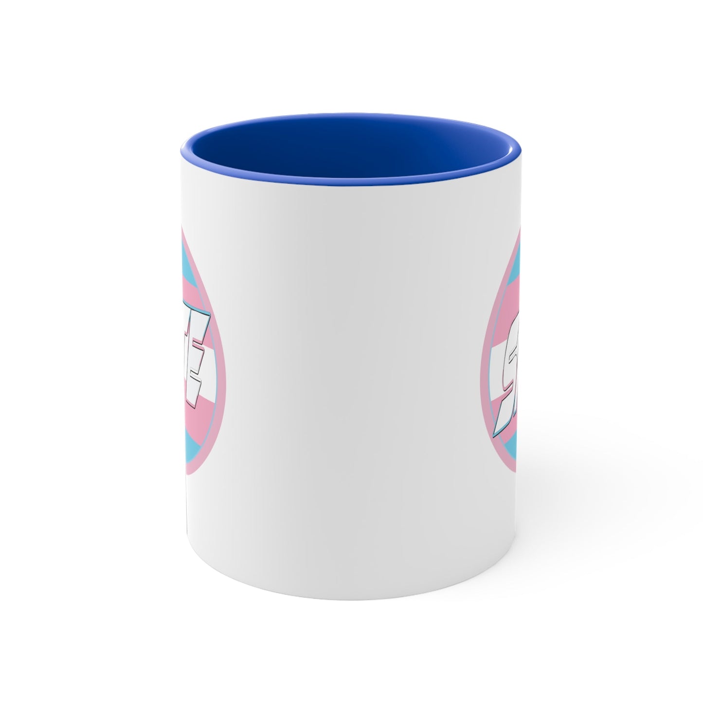 The SKATE trans flag circle design accent mug by Printify features a white exterior, blue handle, and blue interior. It showcases a circular design inspired by the trans flag, incorporating pink, light blue, and white colors. The word "SKATE" is prominently displayed in dynamic white letters at the center of the design.