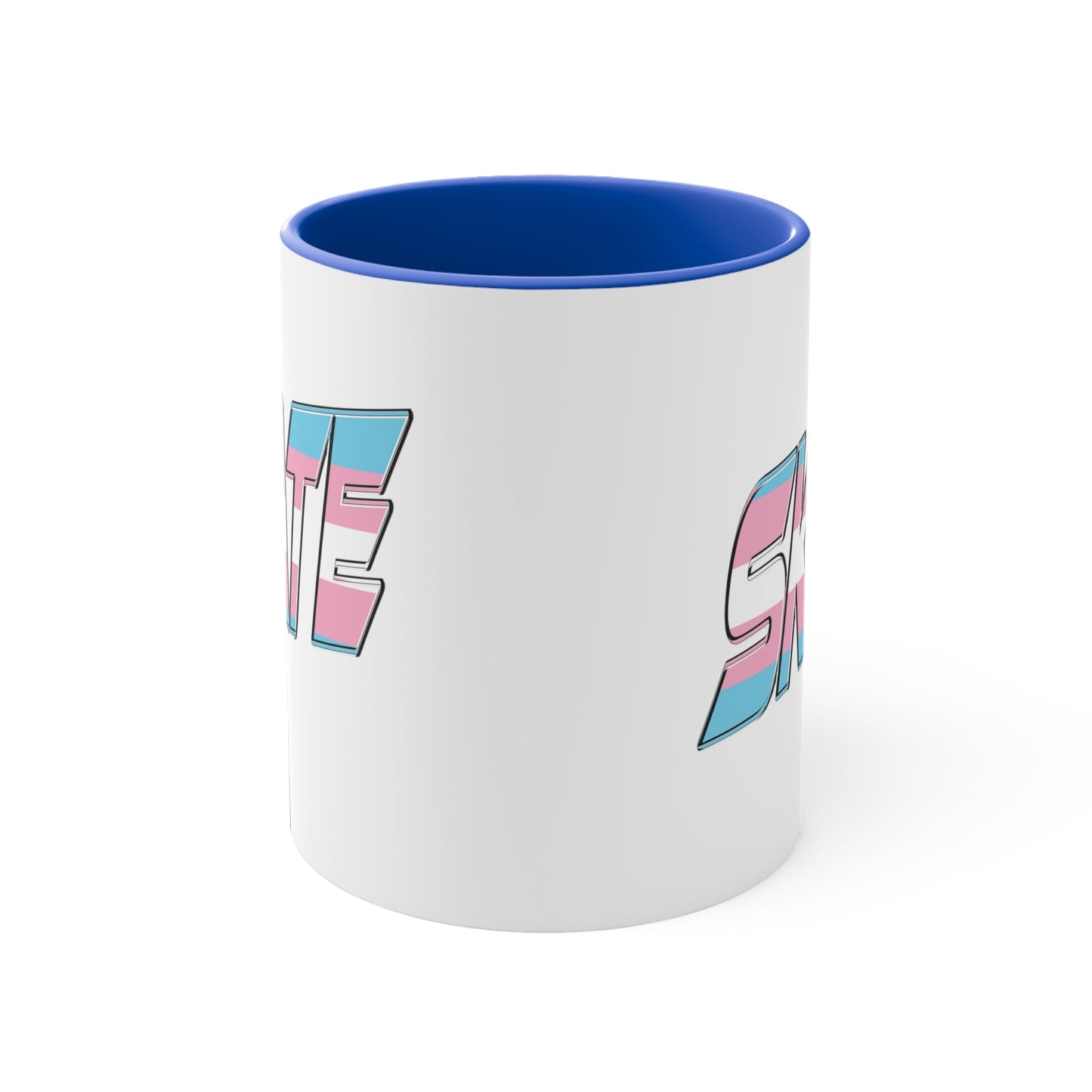 This SKATE trans pride flag accent mug by Printify features a white ceramic base with a blue handle and matching colorful interior. The word "SKATE" is emblazoned in bold letters, styled with vibrant pink and blue tones. Hand wash only to maintain its vivid design.