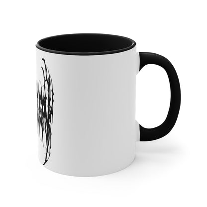 The "SKATING IS GAY but make it death metal accent mug" by Printify is a white mug with a black interior featuring an intricate design that resembles sharp, thorny text. Styled in a death metal font, the symmetrical design has an aggressive, edgy appearance that makes the text difficult to read due to its complex, spiky style.