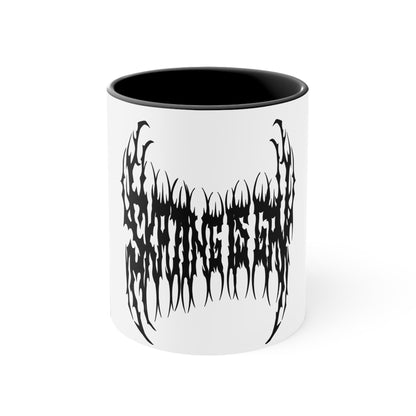 The "SKATING IS GAY but make it death metal accent mug" by Printify is a white mug with a black interior featuring an intricate design that resembles sharp, thorny text. Styled in a death metal font, the symmetrical design has an aggressive, edgy appearance that makes the text difficult to read due to its complex, spiky style.