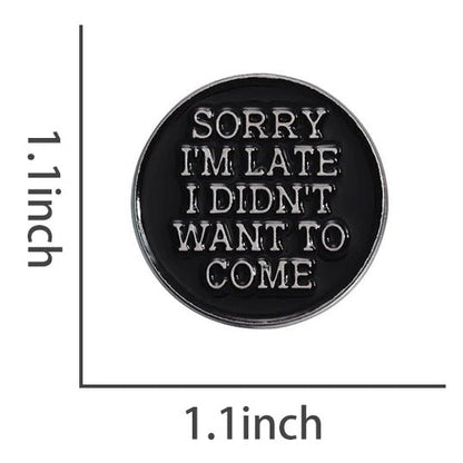 Black and silver round enamel pin with 'Sorry, I'm late. I didn't want to come' text