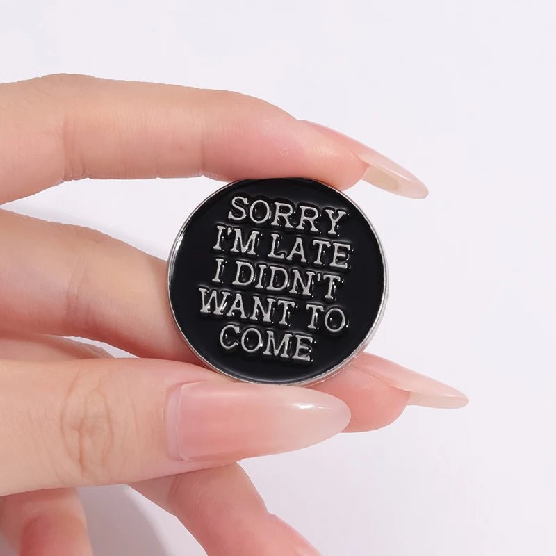 Black and silver round enamel pin with 'Sorry, I'm late. I didn't want to come' text