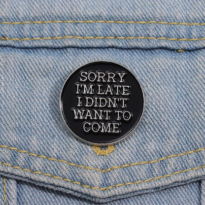 Black and silver round enamel pin with 'Sorry, I'm late. I didn't want to come' text