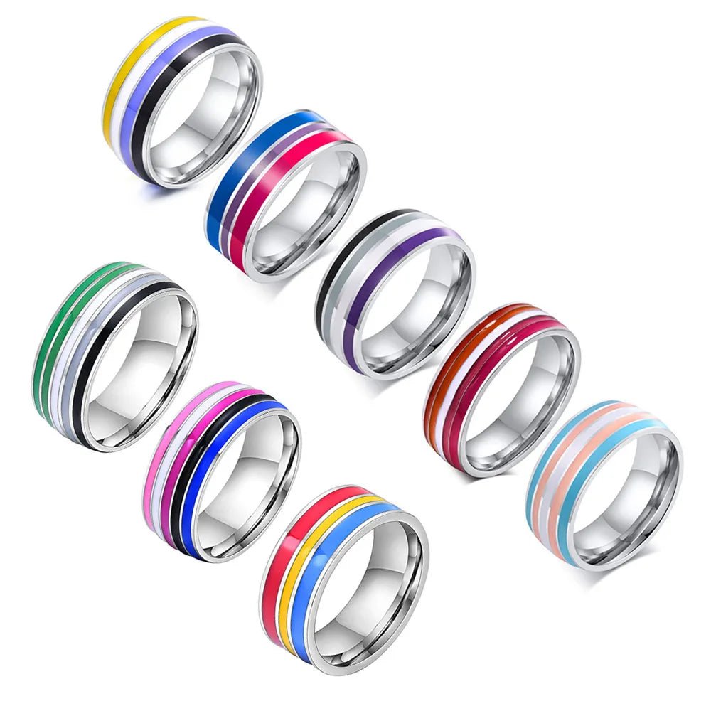 Stainless Steel Pride Flag Ring collection includes seven rings, each with unique colorful flag stripe designs featuring gay, lesbian pansexual bisexual transgender non-binary aromantic genderqueer pride flags. 