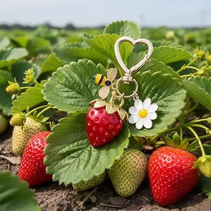 Gold Keychain with heart-shaped clasp, red strawberry, diamante bee, and flower charm