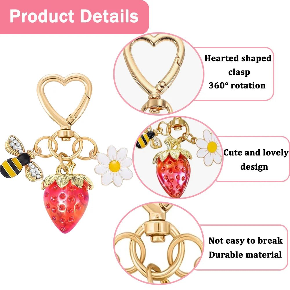 Gold Keychain with heart-shaped clasp, red strawberry, diamante bee, and flower charm