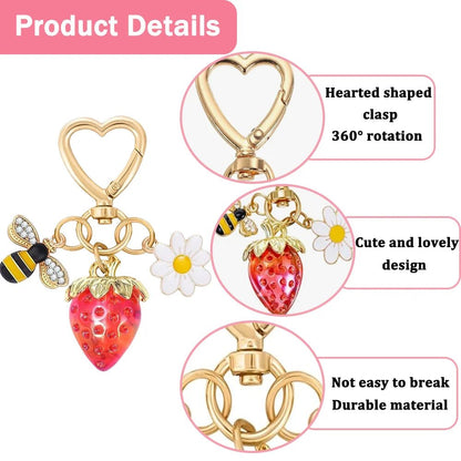Gold Keychain with heart-shaped clasp, red strawberry, diamante bee, and flower charm