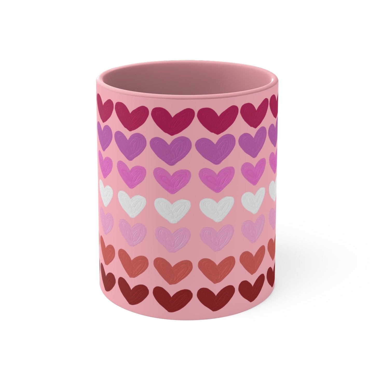 The "Subtle Lesbian Pride Flag - love hearts - colourful accent mug" by Printify is a white ceramic mug with a vibrant interior and red handle, adorned with heart patterns in various shades of pink, purple, and red. The hearts are arranged in horizontal rows, gradually transitioning from lighter shades at the top to darker ones at the bottom.