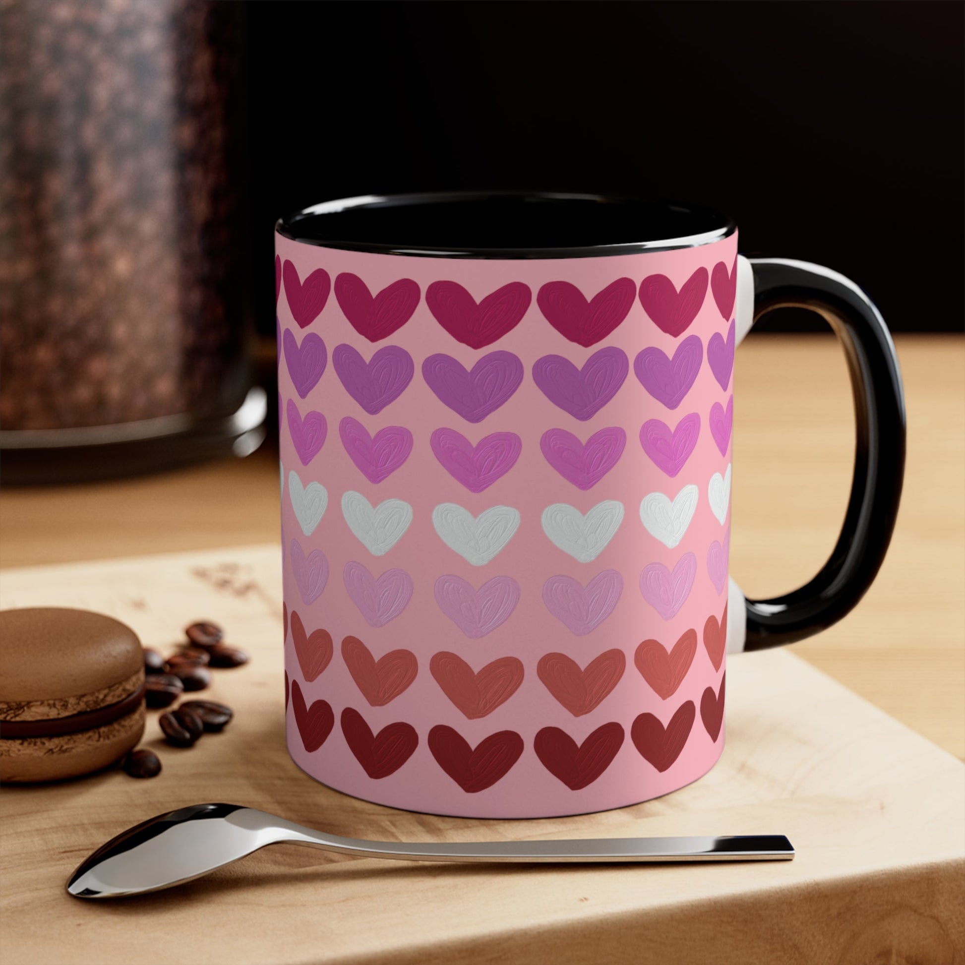 The "Subtle Lesbian Pride Flag - love hearts - colourful accent mug" by Printify is a white ceramic mug with a vibrant interior and red handle, adorned with heart patterns in various shades of pink, purple, and red. The hearts are arranged in horizontal rows, gradually transitioning from lighter shades at the top to darker ones at the bottom.