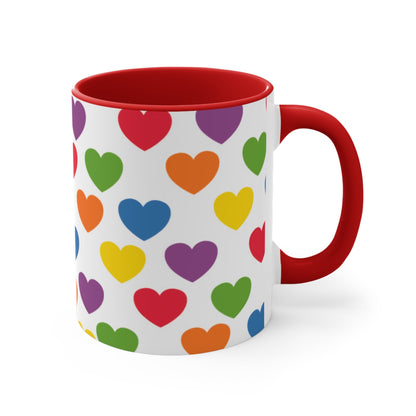 The Subtle Rainbow pride love hearts colourful accent mug by Printify is a white ceramic mug featuring a red handle and a colorful interior, adorned with heart patterns in the vibrant hues of the Rainbow pride flag: red, blue, green, yellow, orange, and purple.