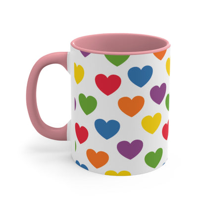 The Subtle Rainbow pride love hearts colourful accent mug by Printify is a white ceramic mug featuring a red handle and a colorful interior, adorned with heart patterns in the vibrant hues of the Rainbow pride flag: red, blue, green, yellow, orange, and purple.