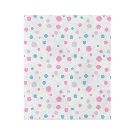 The Subtle Trans Pride Flag - Polka Dot Velveteen Microfiber Blanket by Printify features a super-soft fleece texture and displays an enchanting pattern of pink, blue, and grey polka dots in various sizes, uniformly spread across the white fabric.