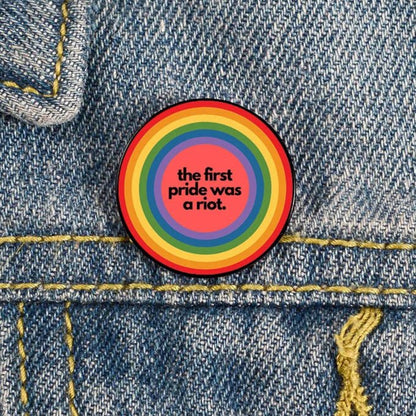 The first pride was a riot rainbow pride badge pin
