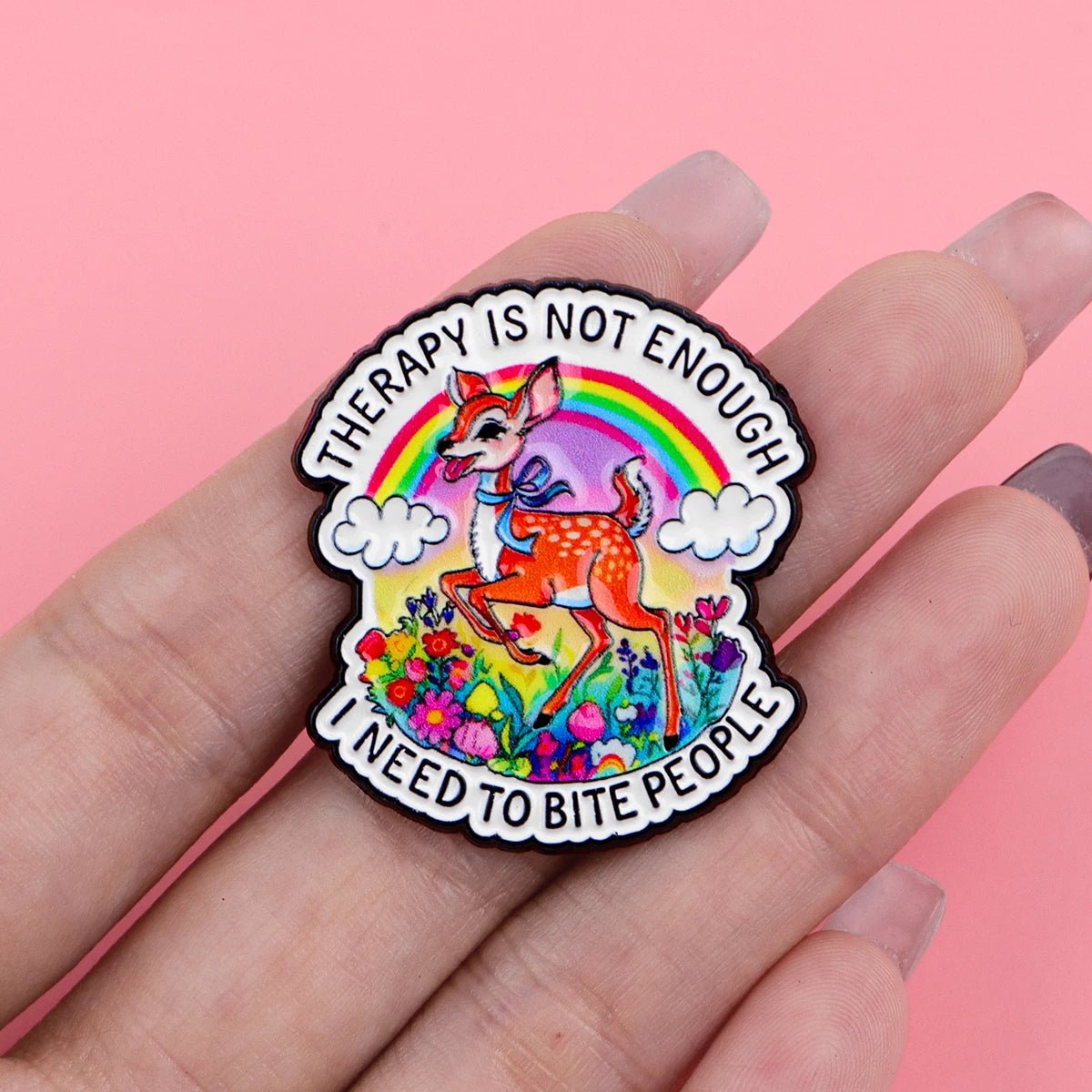 Colorful enamel pin with a deer, rainbow and flowers with text "Therapy Is Not Enough I Need To Bite People"