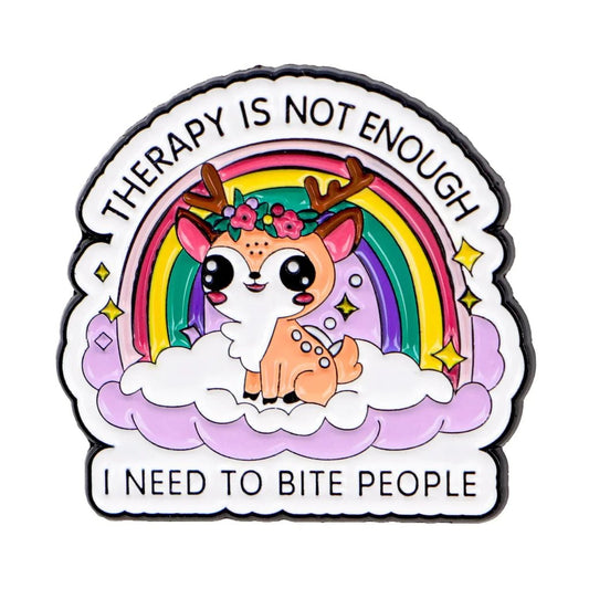 The "Therapy Is Not Enough I Need To Bite People - rainbow deer enamel pin" features a cute cartoon deer with antlers, big eyes, and a flower crown sitting on a purple cloud before a rainbow, with humorous text above and below.
