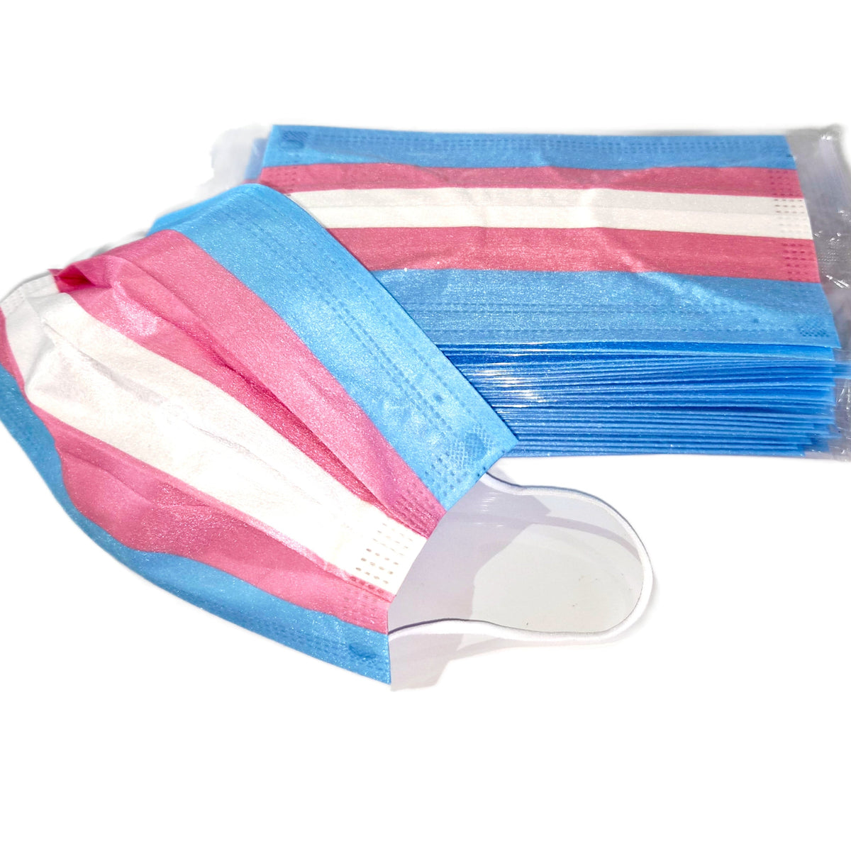 A stack of Trans Pride Disposable Face Masks - 10, 25 or 50 pack featuring horizontal light blue, pink, and white stripes, with one mask resting in front.