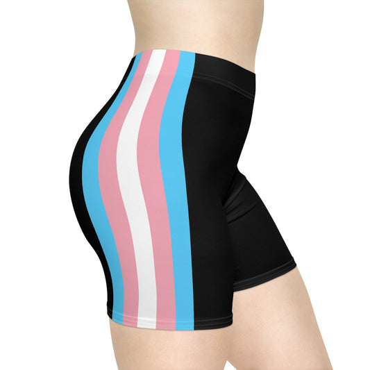 A person wearing Printify's Trans Pride Flag Bike Shorts, which feature vertical stripes in pastel pink, blue, and white on the side to represent the transgender pride flag. The focus is on the lower torso and legs. The shorts are made of moisture-wicking polyester for added comfort.